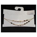 long dark metal chain with a leaf pendent