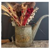 Vintage metal watering can with flowers