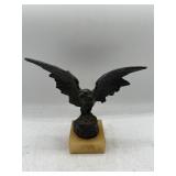 Metal eagle on stone base