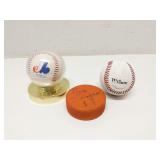 2 baseballs and a signed hockey puck