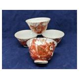 Set of 4 Japanese red glazed porcelain tea bowls