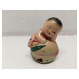 Antique wood baby on a peach pencil sharpener