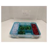 Group of decorative glass beads in storage bin