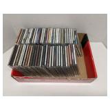 Box of mixed genre music CDs