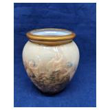 Porcelain vase features a prominent cherub scene