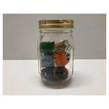 Mason Jar filled with Wooden Spools of Thread