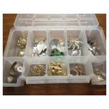 Plastic container full of brooches