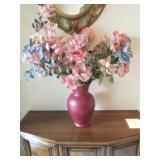 Faux flower arrangement in red vase