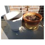 Two plastic planters by garage door