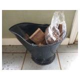 Black metal coal scuttle with firewood