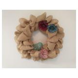 Fabric wreath w/ metal bird on foyer wall