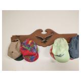 Wood coat rack with some hats