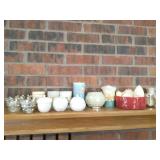 Group of candles and holders on mantle