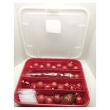 Plastic tote of red Christmas ornaments