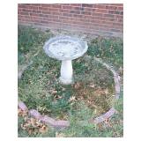 Concrete bird bath in fornt yard