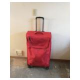 American Tourister red luggage piece, some stains
