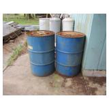 Two Metal Barrels - 1 Empty, 1 Full