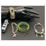 Ladies fashion estate jewelry to include a Nine West stretch bracelet, Carnival cruise line charm bracelet, Scorpio silver-tone enamel star flag bracelet, and more. Five pieces total. See pictures for