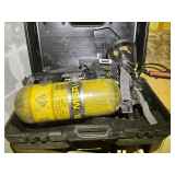Firefighter breathing apparatus with tank, also comes with a storage/carrying case. See pictures for details.