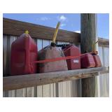 FIVE PLASTIC FUEL CANS UP TO 5 GALLONS