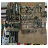 TUBING, HOSE CLAMPS, AND HARDWARE HANGING ON PEGBOARD IN AREA MARKED 1056