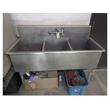 STAINLESS THREE BASIN RESTAURANT SINK AND CLEANING SUPPLIES BELOW