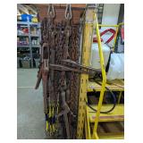 CHAIN, CHAIN BINDERS, AND MORE HANGING FROM SIDE OF WIRE FRAME SHELVING UNIT