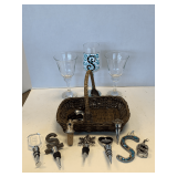 SHELF LOT TO INCLUDE 2 CRYSTAL WINE GLASSES, HAND PAINTED 'S' WINE GLASS & BASKET OF ASSORTED WINE STOPPERS
