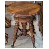 ANTIQUE PIANO STOOL WITH BRASS CLAW FEET AND CLEAR GLASS ROLLERS