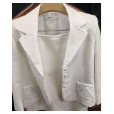 Elegant White Jacquard Skirt Suit from the Tahari by Arthur S. Levine Collection. It Features a Classic Cropped Jacket with Wide Notched Lapels, Stylized Diagonal Pocket Flaps, and a distinctive front