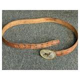Leather belt with a vintage western trophy belt buckle stamped German Silver, see pictures for details.