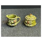 Vintage mid-century ceramic cream pitcher and sugar dish made in Japan featuring a glossy olive green glaze with embossed fruit and leaf reliefs. see pictures for details.