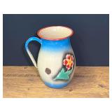 Vintage enameled metal pitcher with a blue-and-yellow gradient finish with a hand-painted floral motif, see pictures for details.