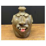 BR2…Steve Turpin Southern folk art pottery face jug featuring an alkaline-glazed brownish finish, protruding clay teeth, and a pink tongue sticking out, see pictures for details.