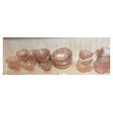 DR… Shelf lot of pink Depression glass in the “Cherry Blossom” pattern to include dessert cups, berry bowls, bowls, and cups. See pictures for details.