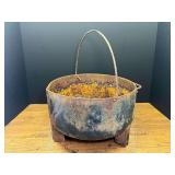 Garage…Vintage cast-iron footed cauldron kettle with wire handle, side handle and spout. See pictures for details.