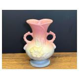 LR…Vintage Hull Art Pottery double-handled vase with an embossed pink magnolia flower set against a pastel pink and blue matte finish. See pictures for details.