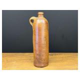 Garage…Antique salt-glazed stoneware mineral water bottle from the 19th century, featuring a cylindrical brown clay body and an embossed stamp near the base reading "Amsterdam”. see pictures for d
