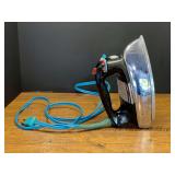 Garage… GE iron, powers up, see pictures for details.