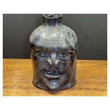 LR…Folk art pottery face jug with a dark glazed finish and an expressive sculpted face from Ila, Georgia.. See pictures for details.