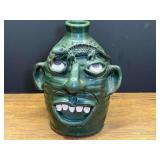 LR… Signed ugly face stoneware jug, with handle, see pictures for details.