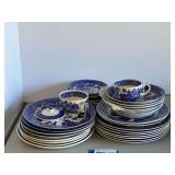 Garage…Blue Willow patterned ceramic dishware, a highly recognizable style of blue-and-white transferware tableware. Includes dinner plates, cups, saucers, and bowls. Approximately 36 pieces. See pi
