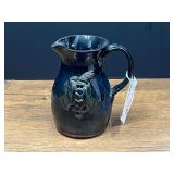 BR2…Dark glazed pottery pitcher, resembling folk art pottery with a molded grape cluster and vine motif characteristic of Gillsville, Georgia folk art pottery from the Ferguson family. See pictures 