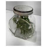 Decorative jar with green foliage