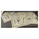 Several 100 share stock certificates for