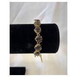 Gold Tone Bracelet with Nine Smoke Heart Shaped