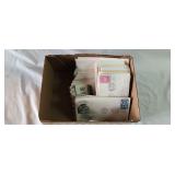 Box of letter envelopes with stamps