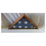 Folded American flag in triangle display case
