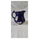 Antique blue porcelain pitcher with ruffled edges