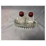 Salt and pepper shaker set with glass stand